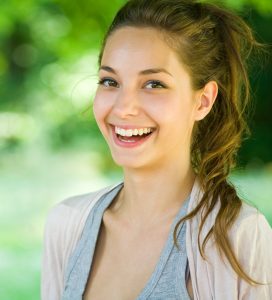 'woman smiling after wisdom teeth removal'