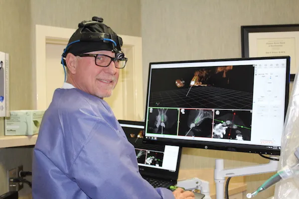 Dr Tillery looking at a computer