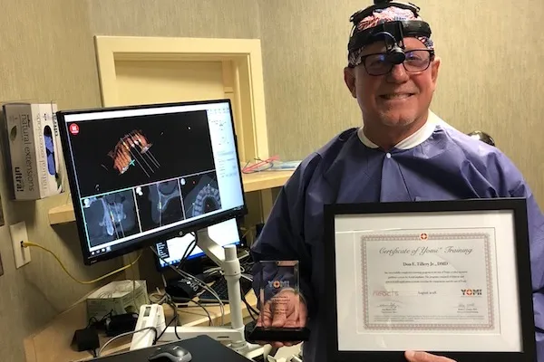 Dr Tillery holding an award