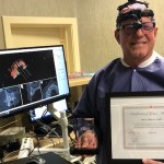 Dr Tillery holding an award