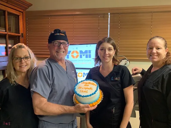 Staff holding a cake