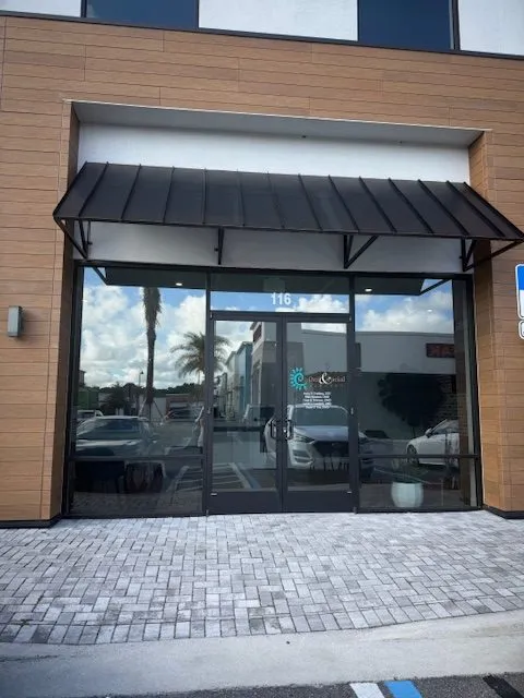 Ocoee location, A modern storefront with wood siding and a black metal awning